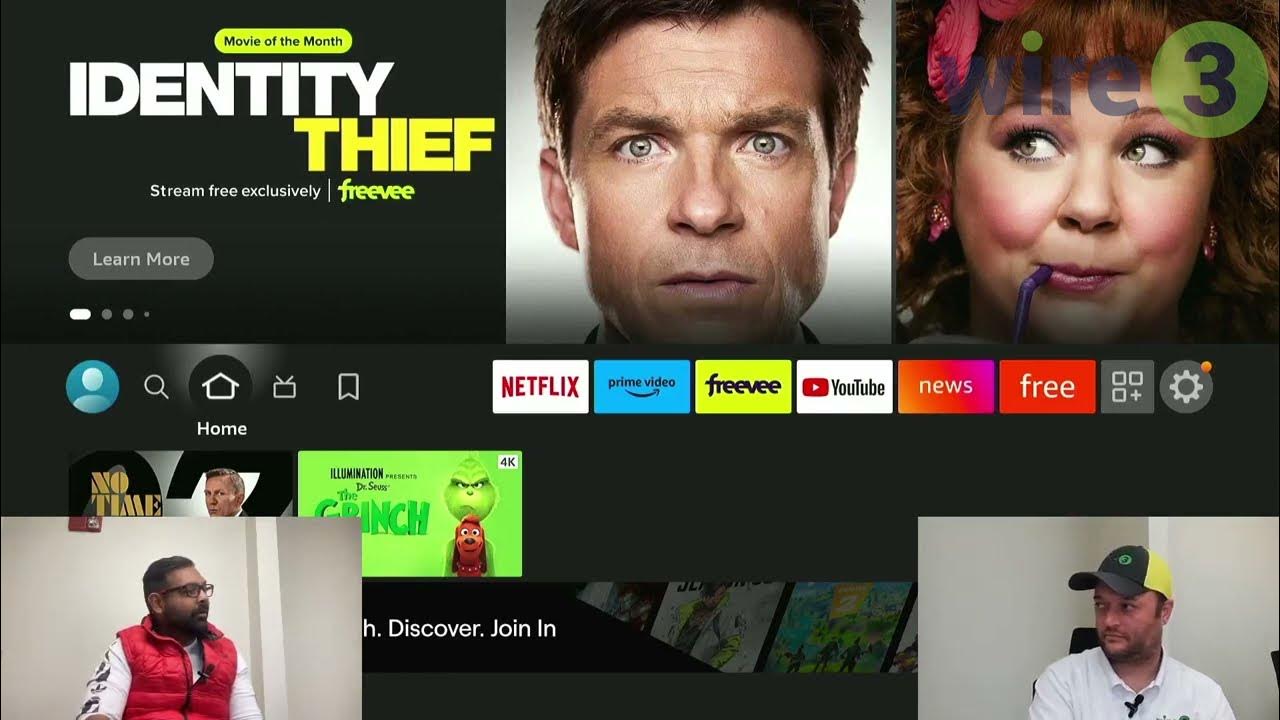 person holding firestick in front of tv